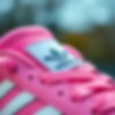 Close-up of adidas logo on pink sports shoes