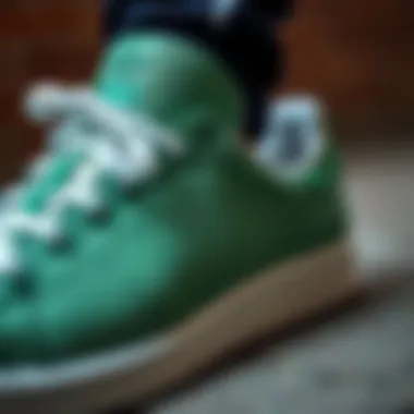 Close-up of Adidas Stan Smith green shoe detailing
