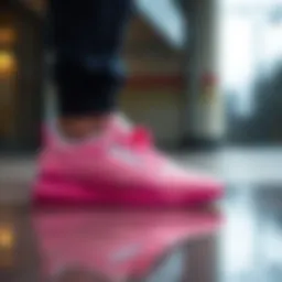 Stylish pink Reebok shoes on a reflective surface